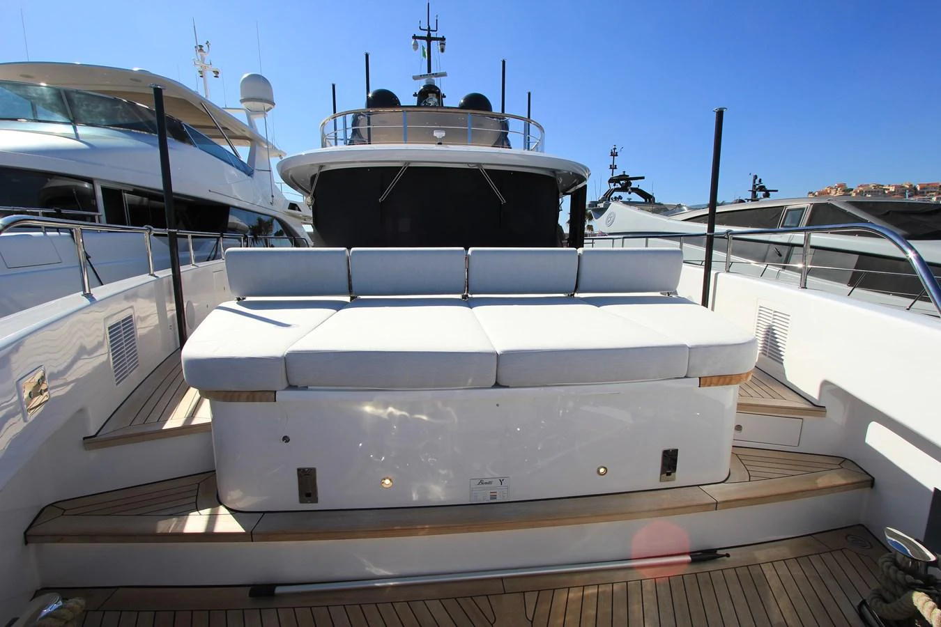 The aft deck features a spacious sunbathing area with comfortable cushions and sleek design. aboard OASIS 34M BO212 Yacht for Sale