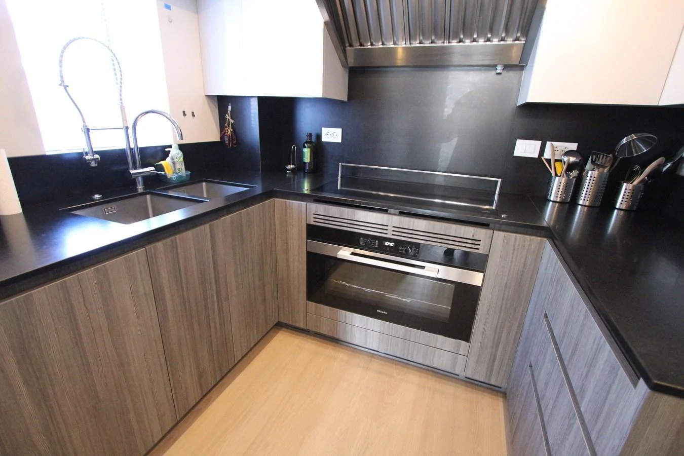 The modern galley features sleek cabinetry, stainless steel appliances, and ample counter space. aboard OASIS 34M BO212 Yacht for Sale