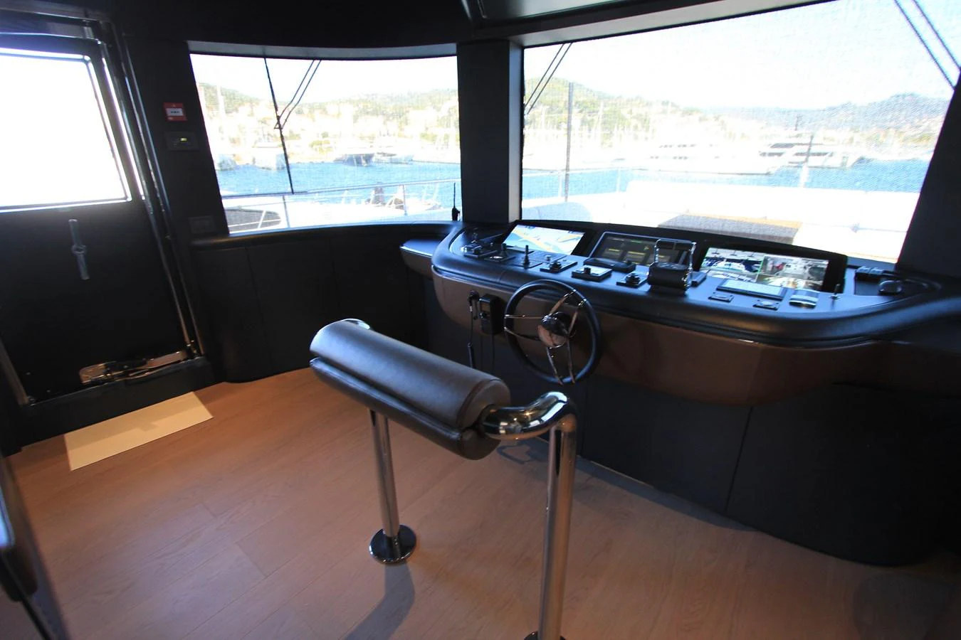 The helm station offers a commanding view with state-of-the-art navigation equipment and a sleek, modern design. aboard OASIS 34M BO212 Yacht for Sale