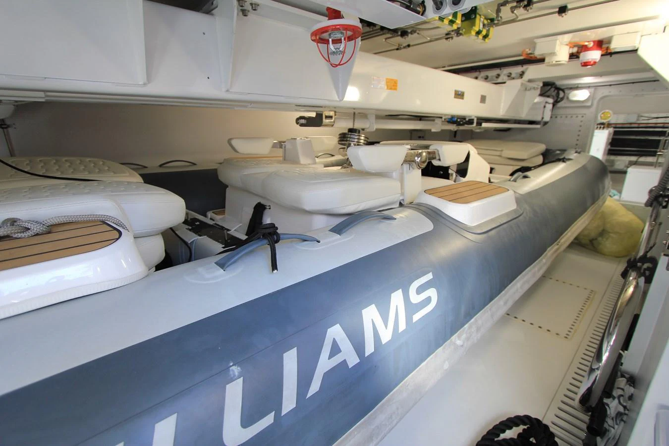 The image showcases a well-maintained tender stored inside the yacht's garage. aboard OASIS 34M BO212 Yacht for Sale