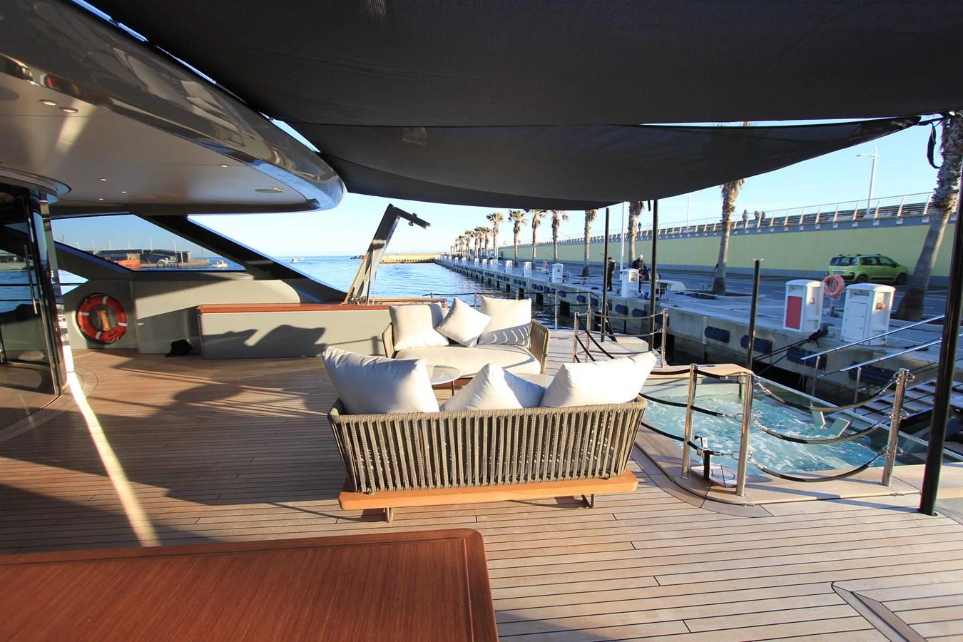 The aft deck offers a spacious and inviting area for relaxation with comfortable seating and a view of the marina. aboard OASIS 34M BO212 Yacht for Sale
