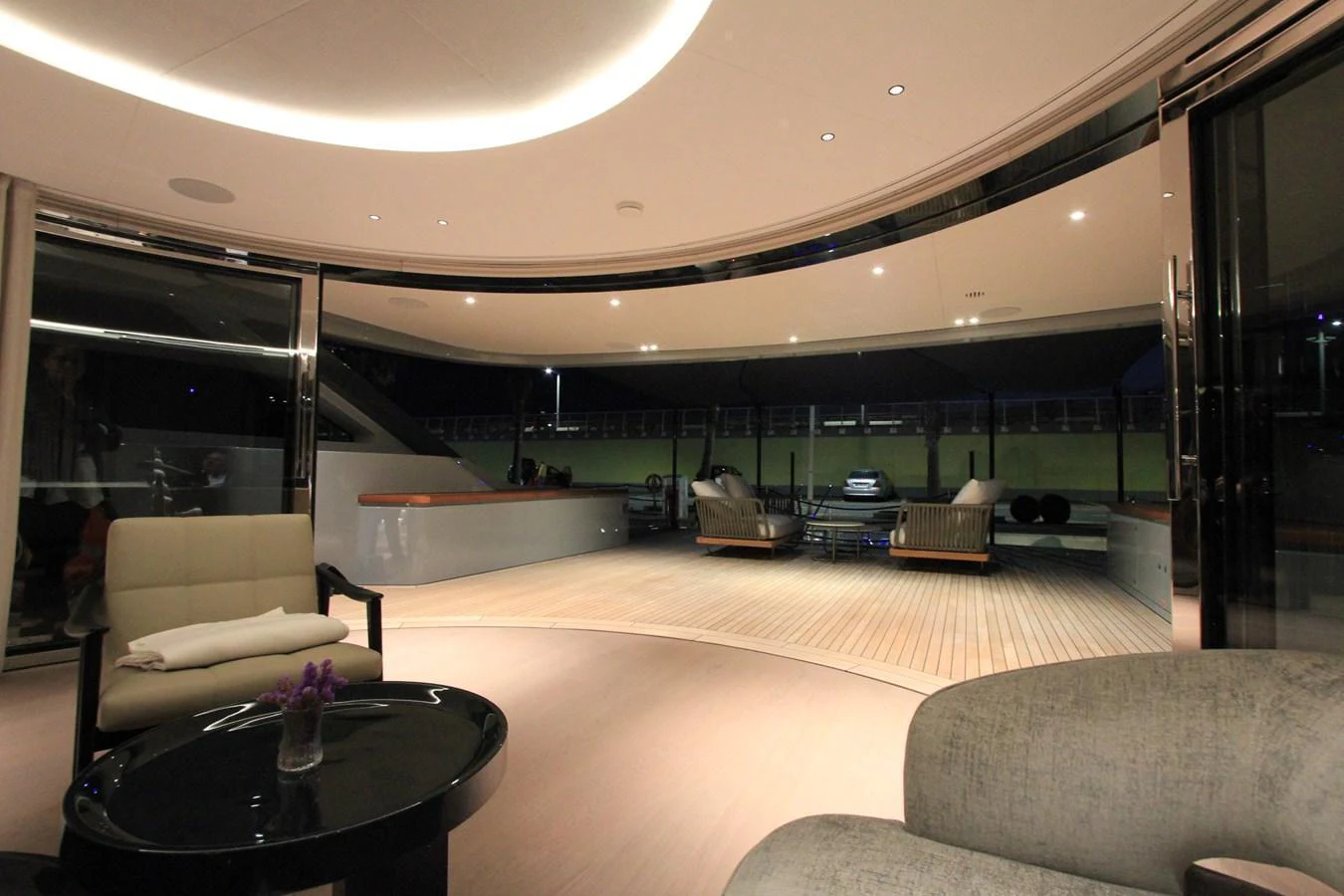 The yacht's salon offers a spacious and modern area with elegant seating and a seamless transition to the exterior deck. aboard OASIS 34M BO212 Yacht for Sale