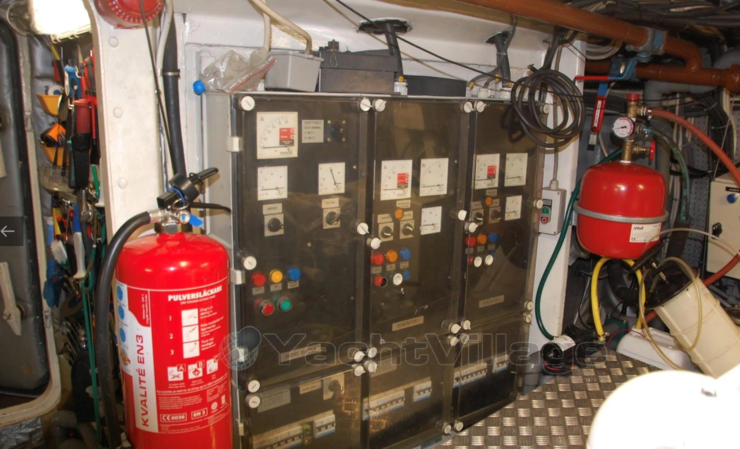 The image showcases the yacht's engine room with various control panels and safety equipment. aboard UNITED SPIRIT Yacht for Sale