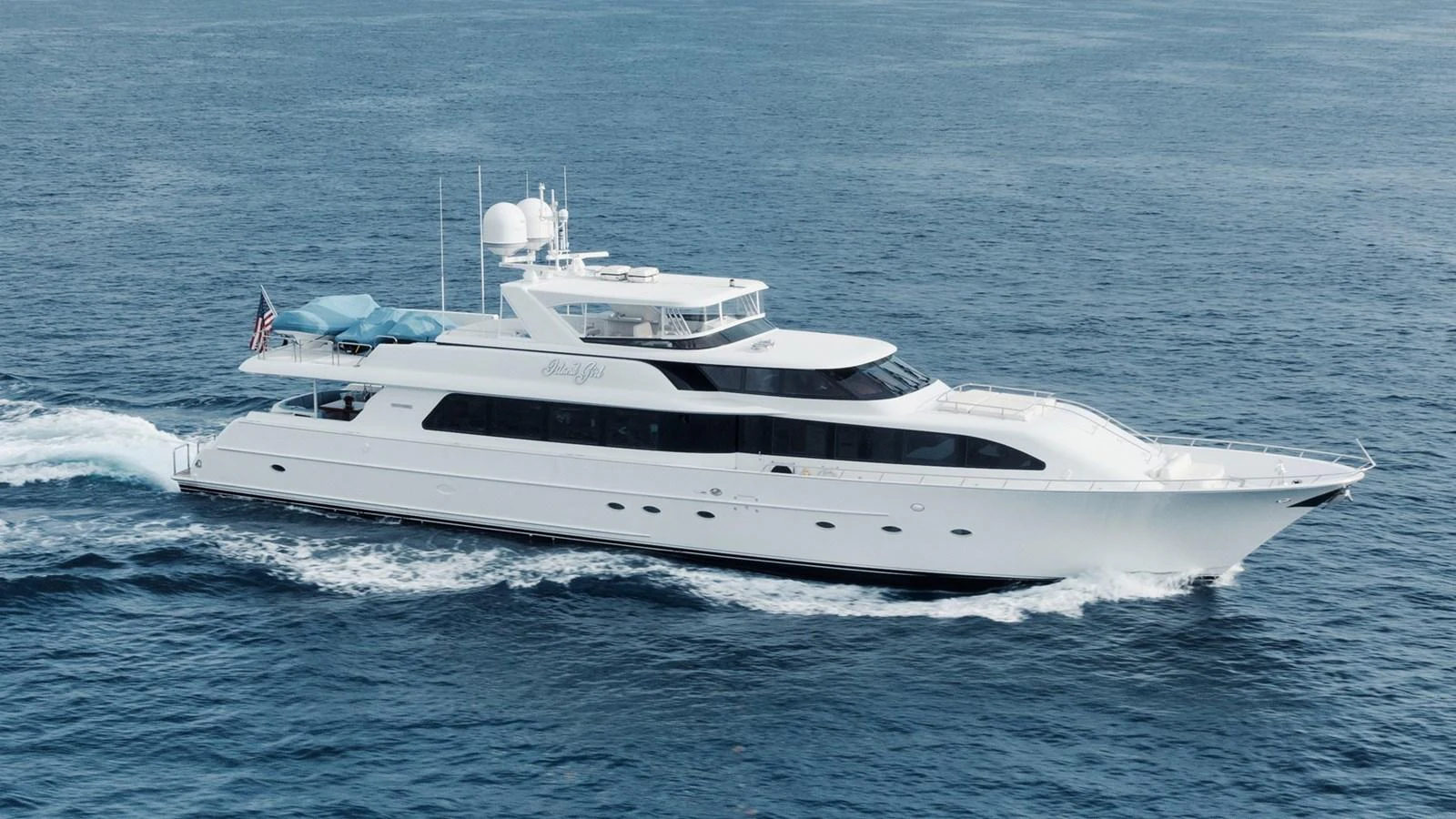 A sleek and elegant yacht cruising through calm waters, showcasing its luxurious design and spacious decks. aboard ISLAND GIRL Yacht for Sale
