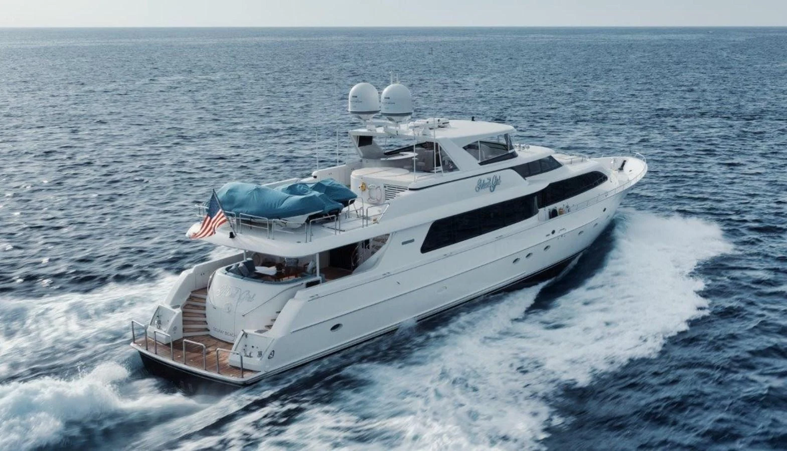 A sleek and spacious yacht cruises through the open sea, showcasing its elegant design and luxurious amenities. aboard ISLAND GIRL Yacht for Sale