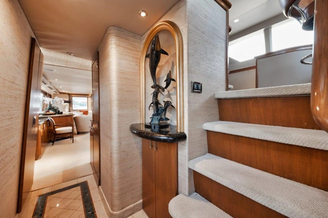 The yacht's interior features a stylish stairway leading to a well-appointed lower deck. aboard ISLAND GIRL Yacht for Sale