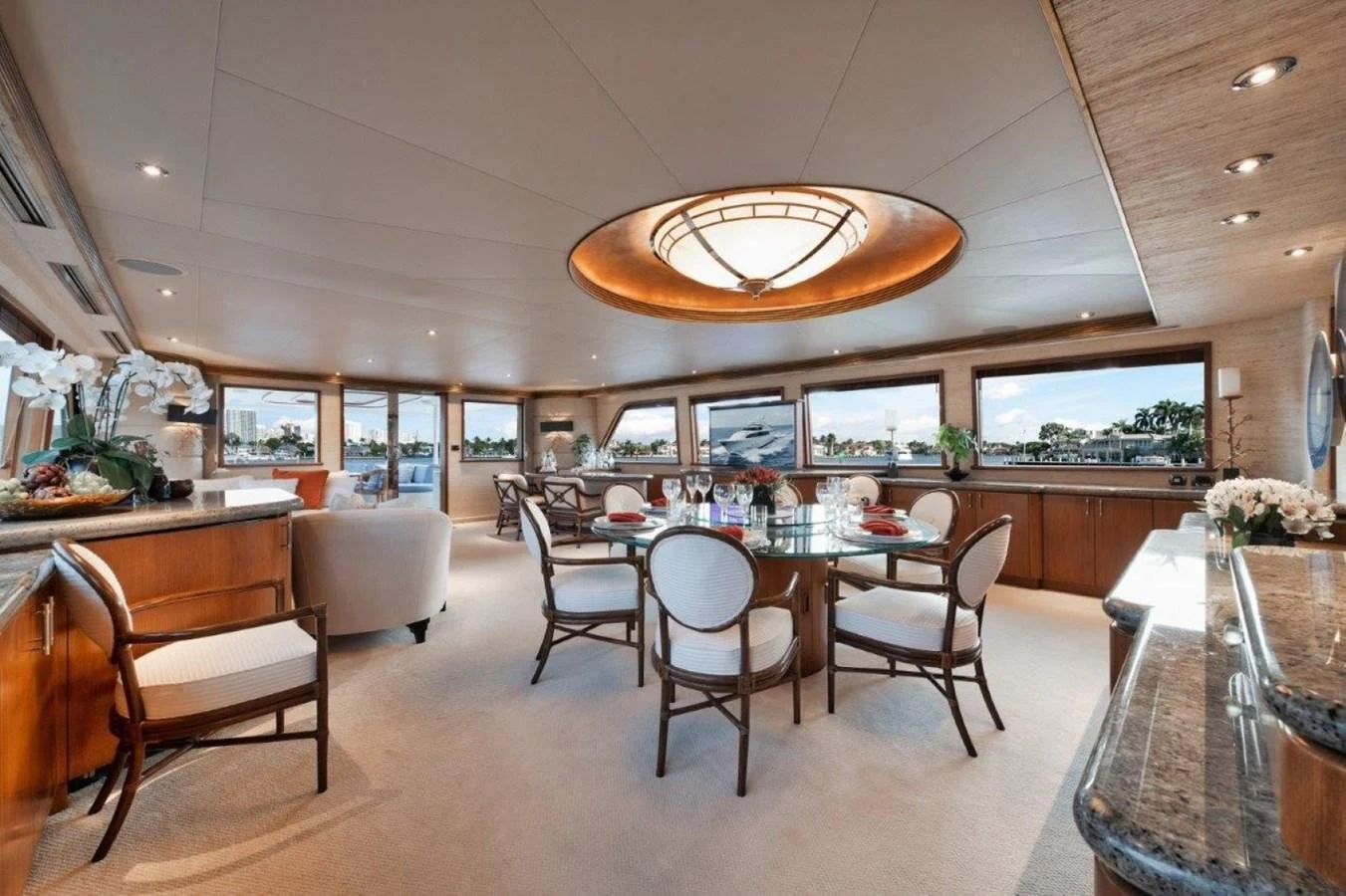 The yacht's dining area features elegant seating and panoramic windows, creating a luxurious and inviting atmosphere. aboard ISLAND GIRL Yacht for Sale