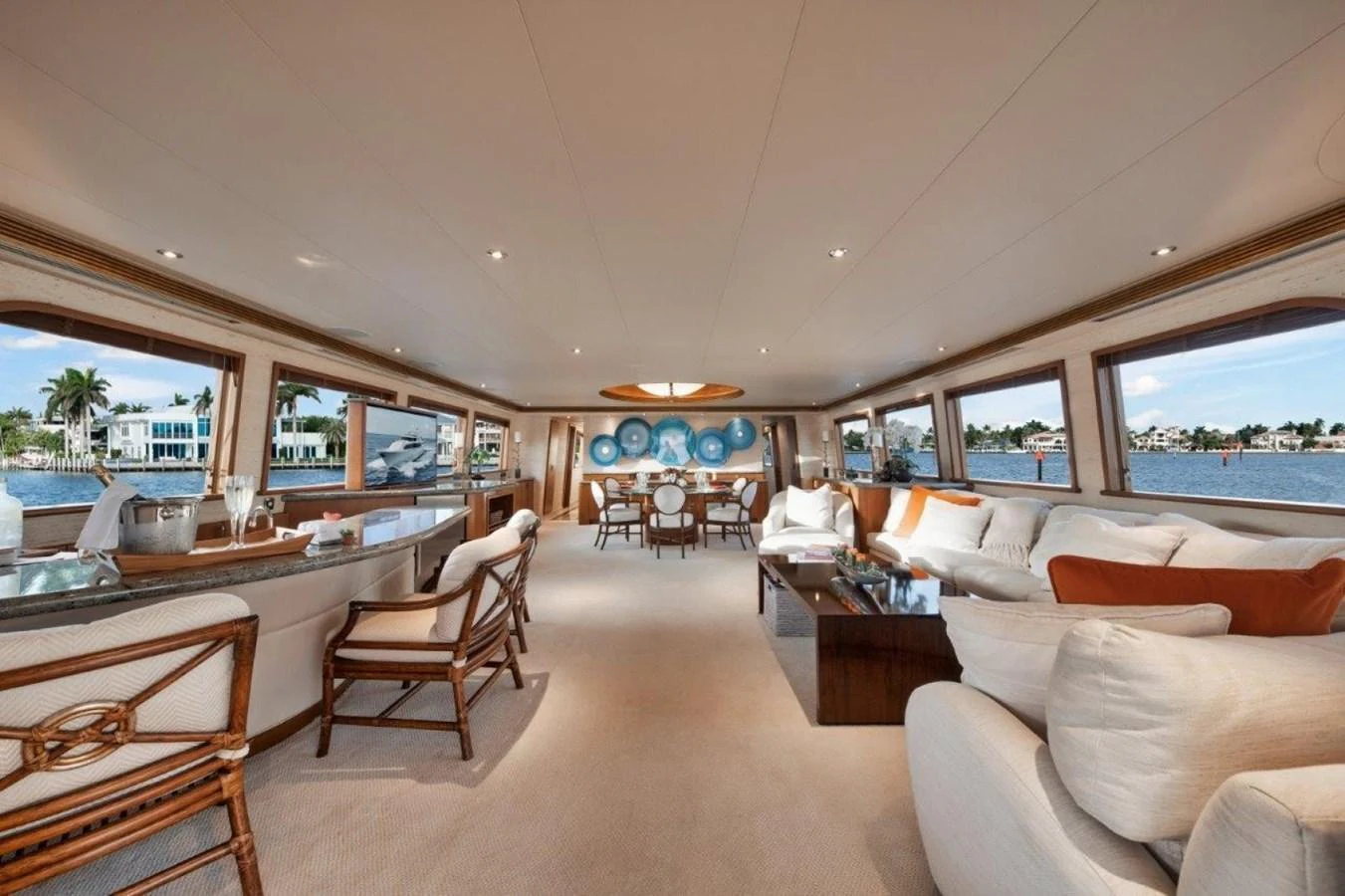 The spacious salon features elegant furnishings and panoramic windows offering stunning views. aboard ISLAND GIRL Yacht for Sale