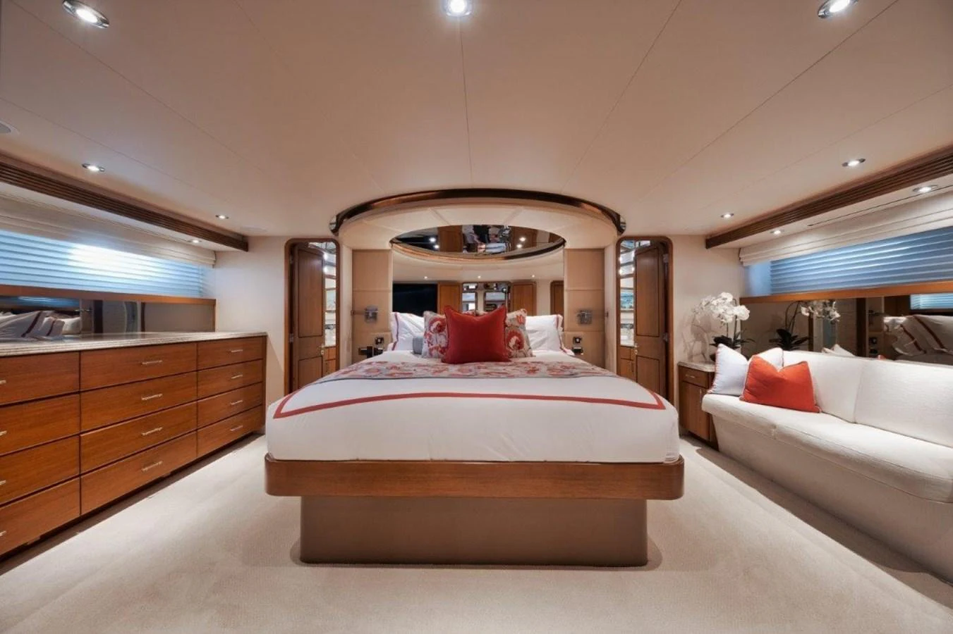 The master stateroom features a luxurious bed, elegant wood cabinetry, and ample natural light. aboard ISLAND GIRL Yacht for Sale