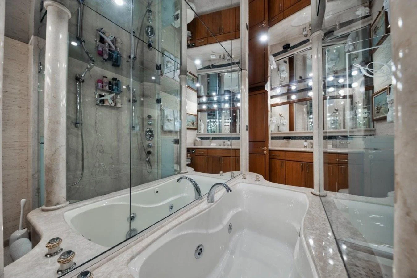 The luxurious bathroom features a spacious bathtub and elegant fixtures, surrounded by mirrors and marble accents. aboard ISLAND GIRL Yacht for Sale