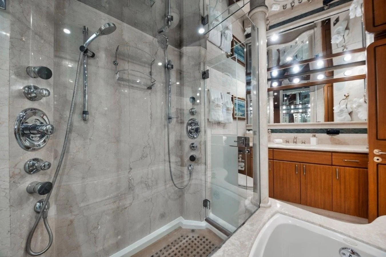 The luxurious bathroom features a spacious glass-enclosed shower and elegant wooden cabinetry. aboard ISLAND GIRL Yacht for Sale
