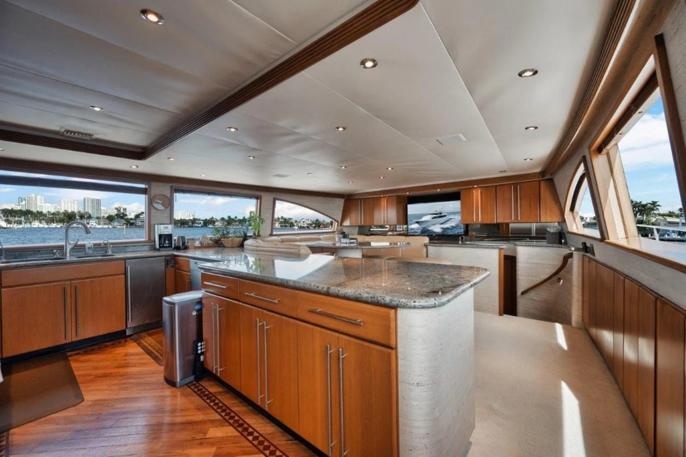 The yacht's galley features elegant wood cabinetry, granite countertops, and ample natural light from large windows. aboard ISLAND GIRL Yacht for Sale