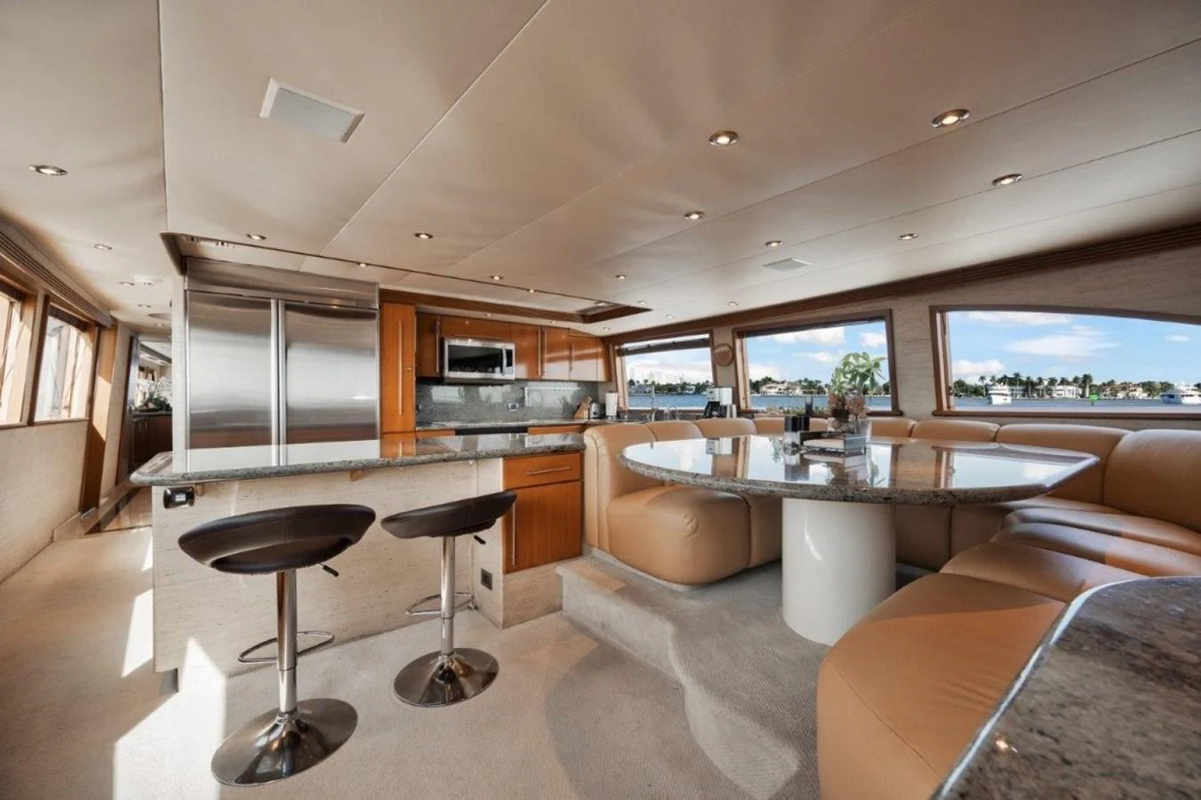 The yacht's galley features a modern kitchen and a comfortable dining area with panoramic windows. aboard ISLAND GIRL Yacht for Sale
