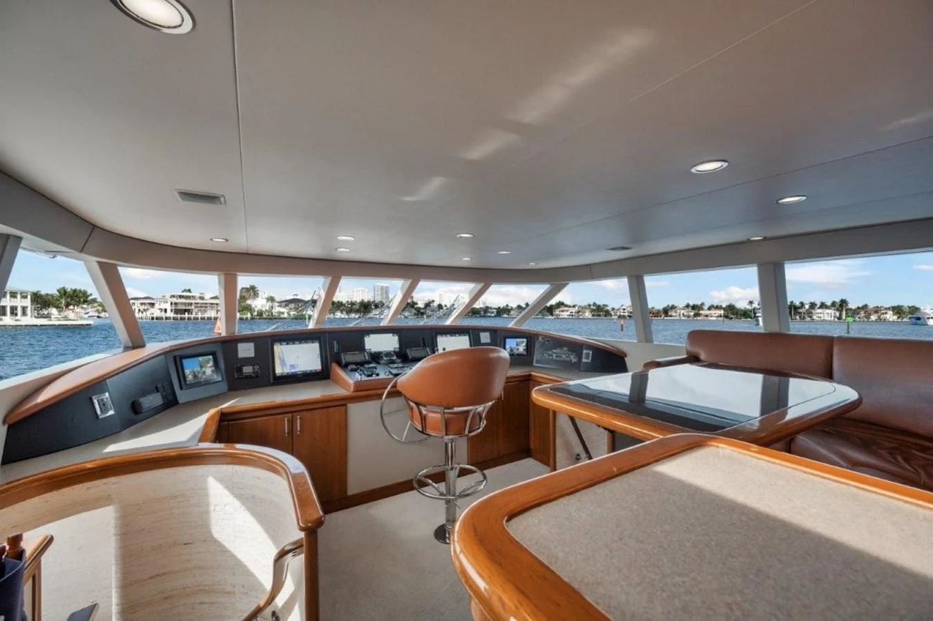 The helm station offers a panoramic view with state-of-the-art navigation equipment and luxurious seating. aboard ISLAND GIRL Yacht for Sale
