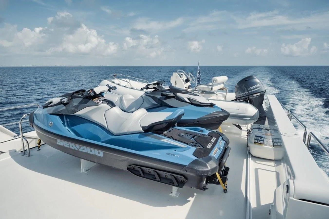 The yacht features a well-equipped deck with multiple jet skis and a tender, perfect for water sports enthusiasts. aboard ISLAND GIRL Yacht for Sale