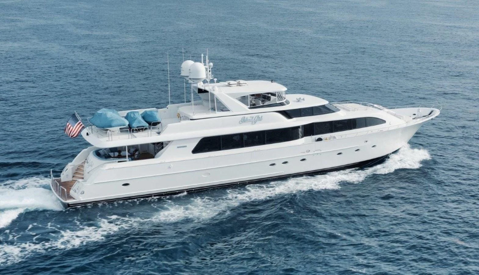 A sleek and elegant yacht cruises smoothly on the open water, showcasing its luxurious design and spacious decks. aboard ISLAND GIRL Yacht for Sale