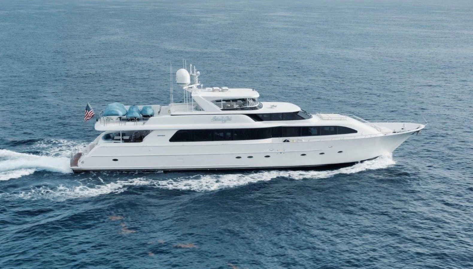 A sleek and elegant yacht cruises smoothly on the open sea, showcasing its luxurious design and spacious decks. aboard ISLAND GIRL Yacht for Sale