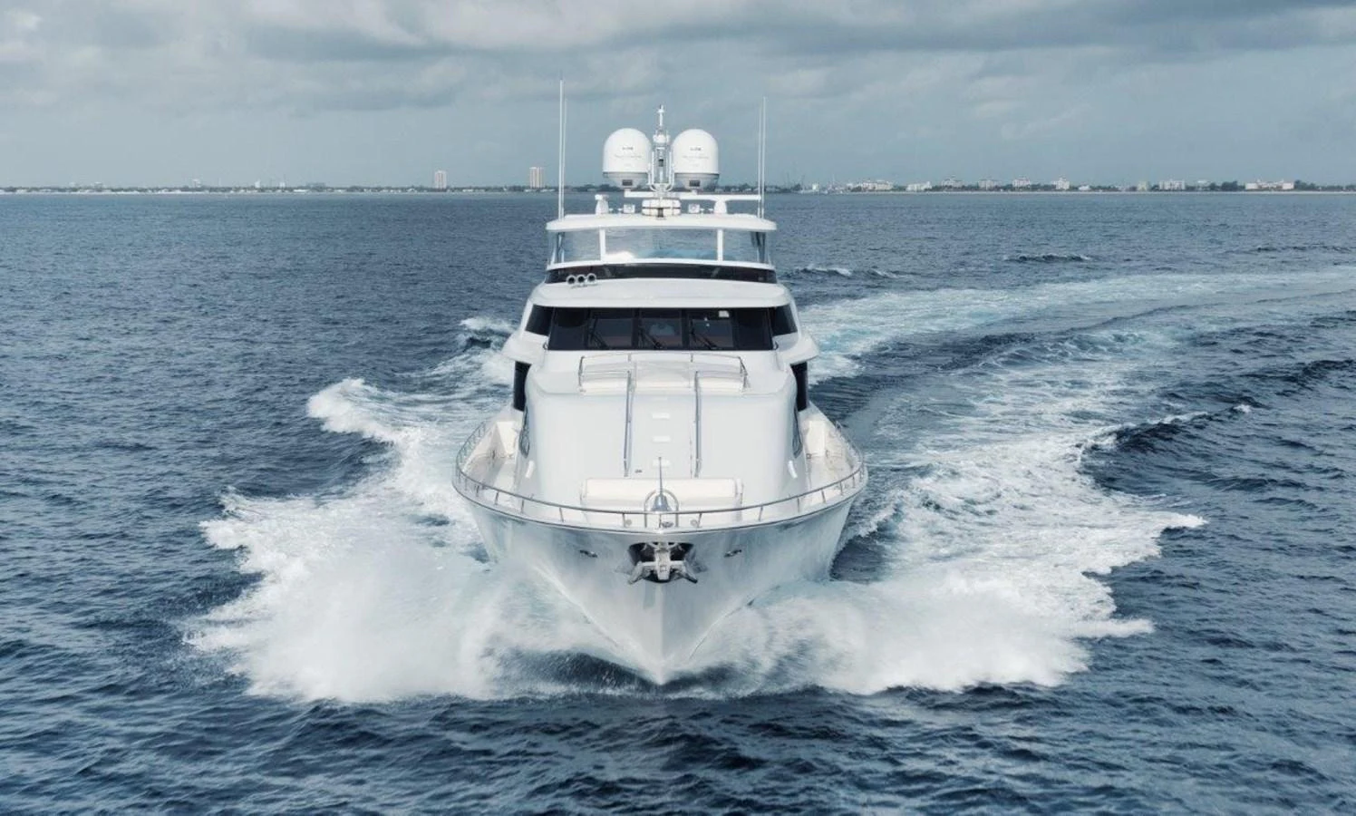 A sleek yacht cruises powerfully through the open water, showcasing its impressive design and performance. aboard ISLAND GIRL Yacht for Sale