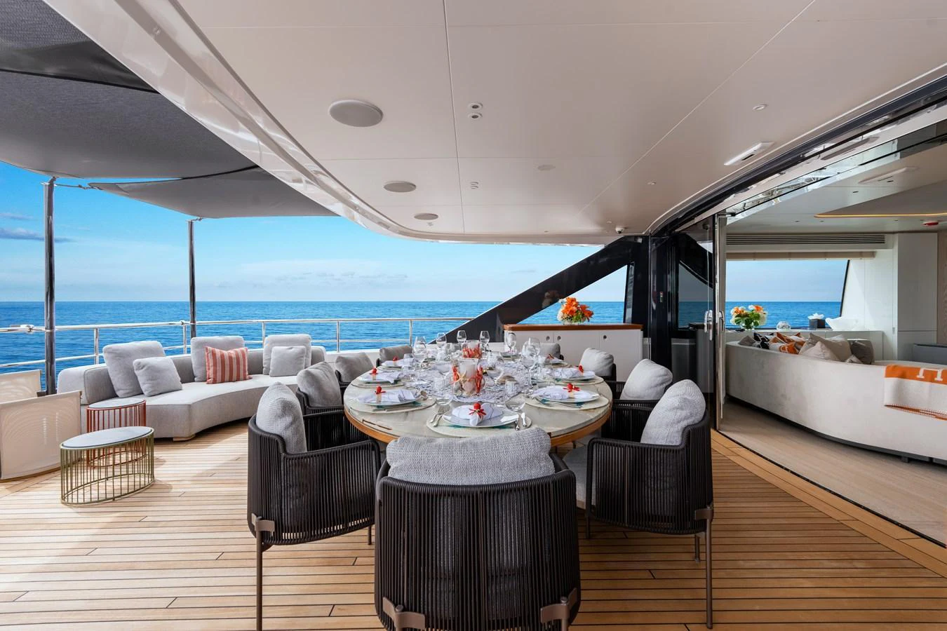 The aft deck offers an elegant dining area with a seamless transition to the luxurious indoor lounge. aboard A+ Yacht for Sale