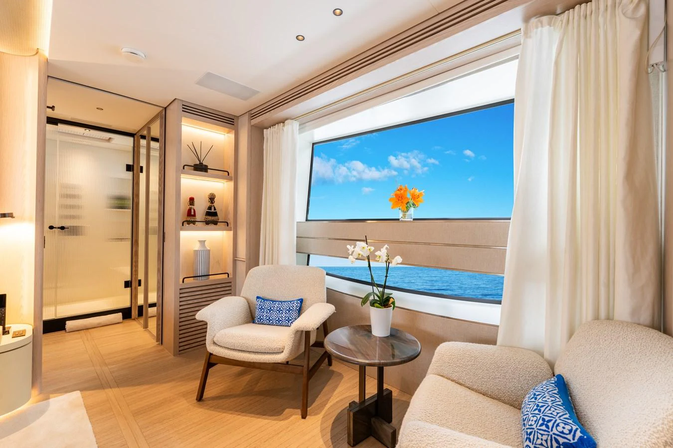 The salon offers a serene and inviting space with a large window providing a stunning ocean view. aboard A+ Yacht for Sale