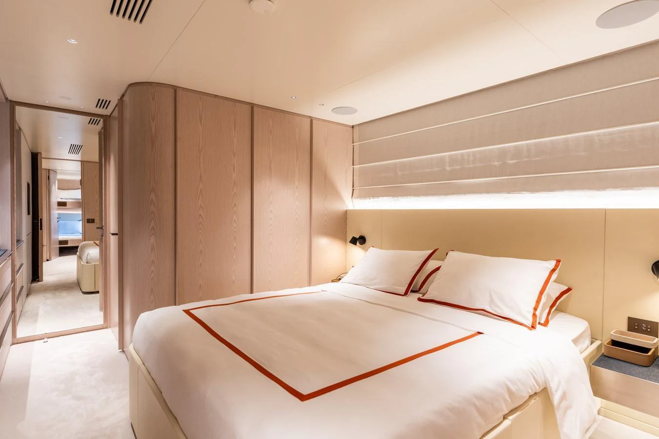 The stateroom features a luxurious bed with elegant linens and ample natural light. aboard A+ Yacht for Sale