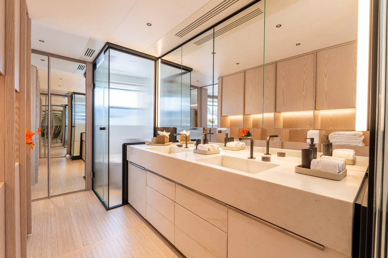 The yacht's bathroom features a spacious and modern design with double sinks and ample storage. aboard A+ Yacht for Sale