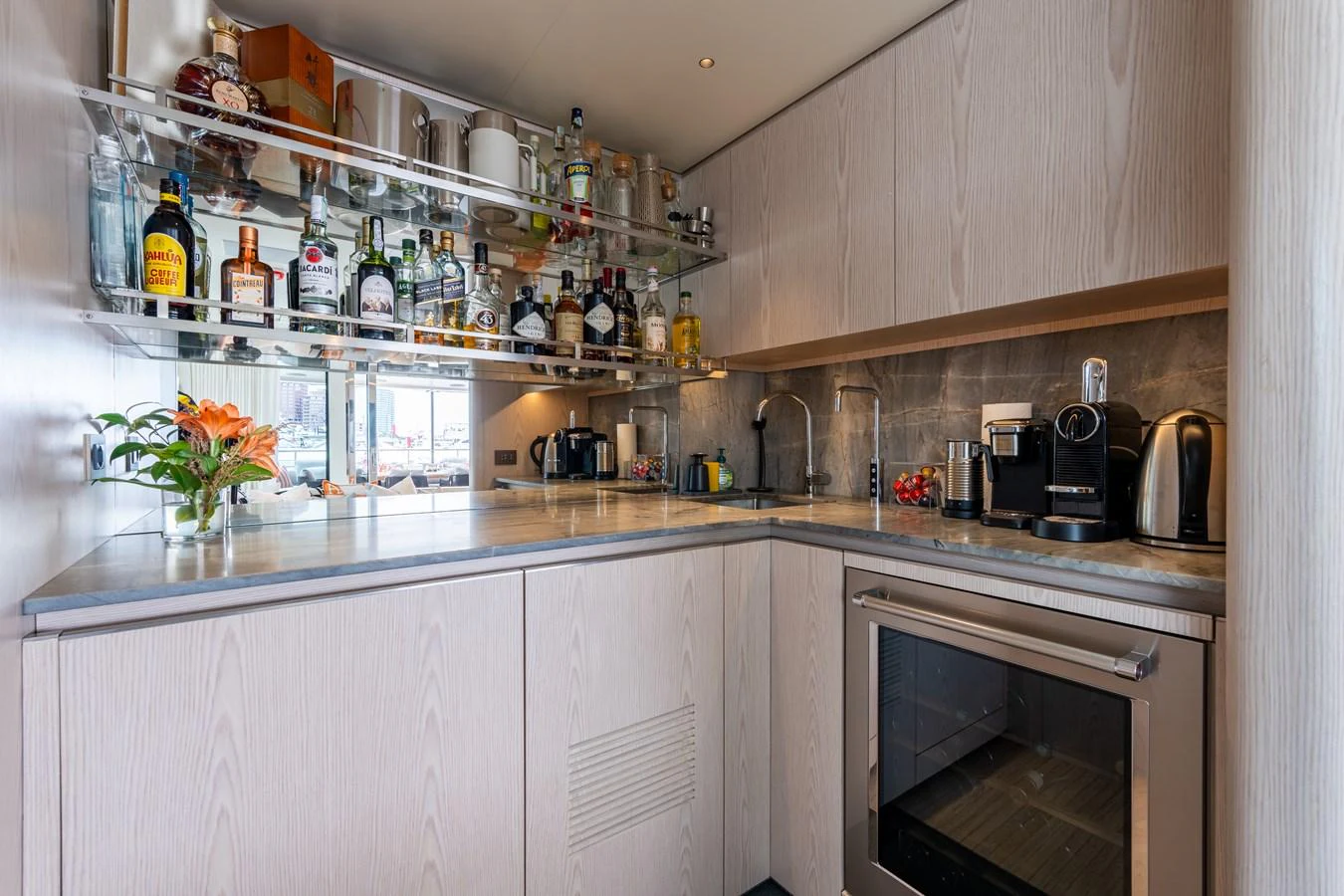The yacht's galley is well-equipped with modern appliances and a variety of beverages. aboard A+ Yacht for Sale