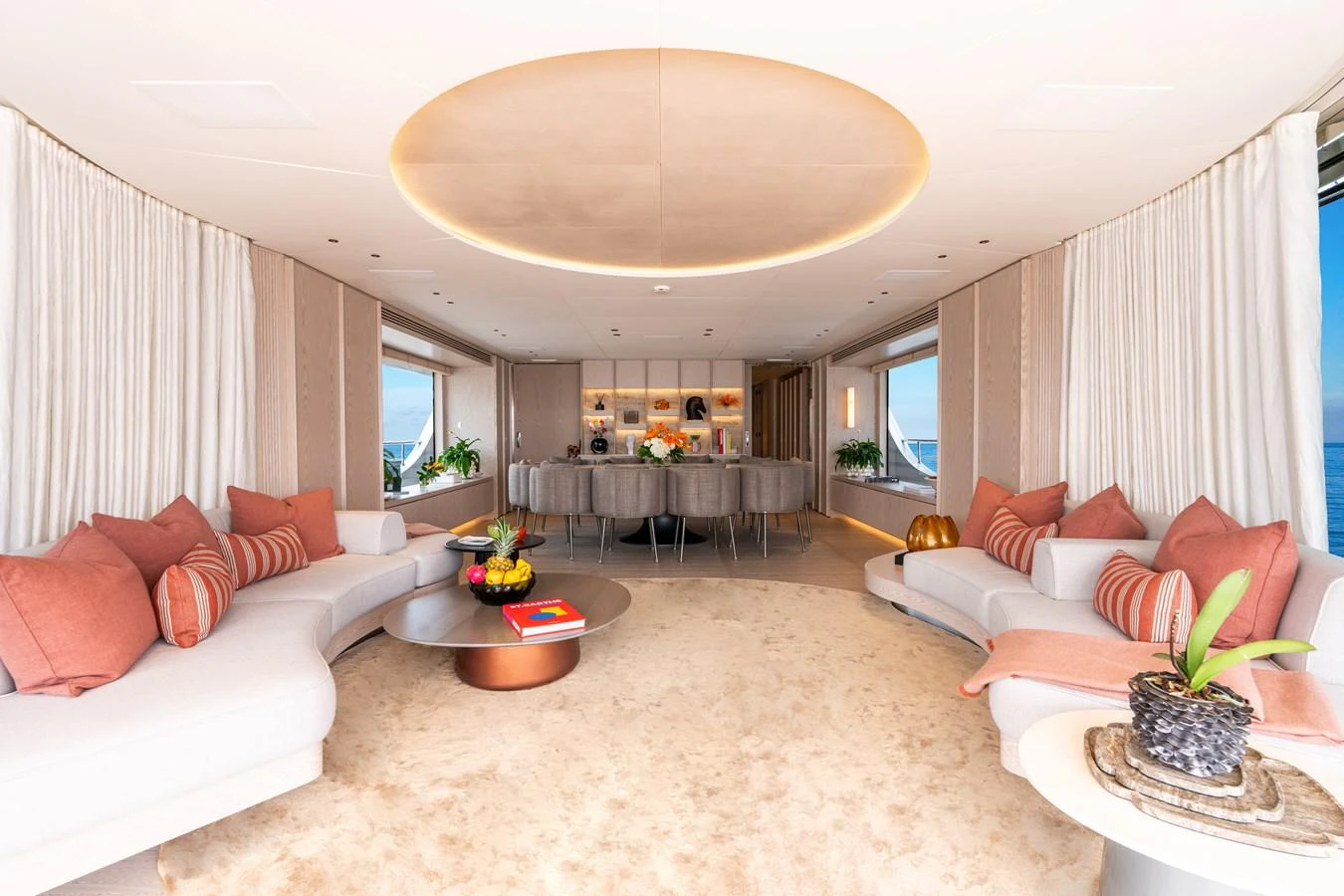 The salon features plush seating, elegant decor, and panoramic windows offering stunning sea views. aboard A+ Yacht for Sale