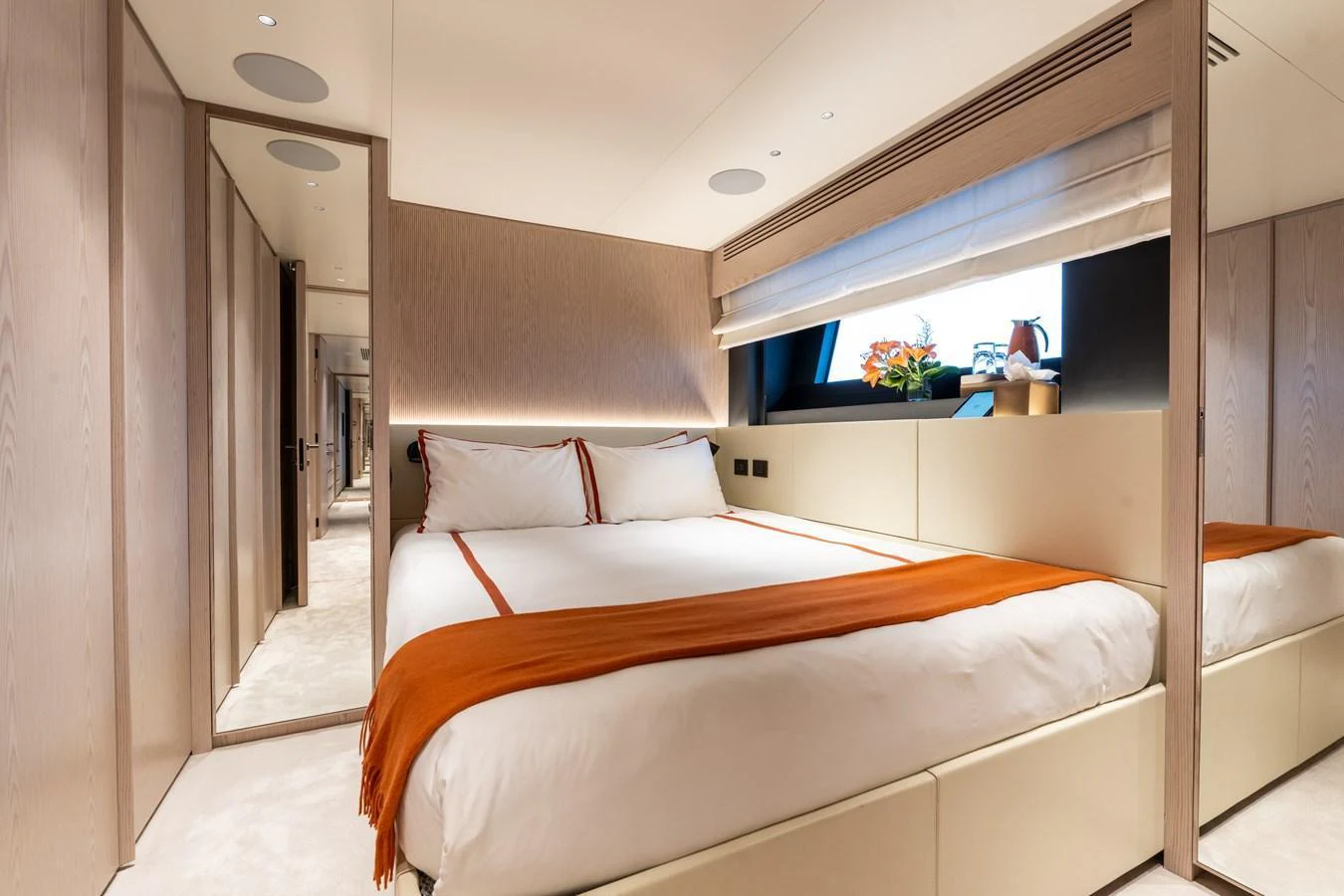 The stateroom features a luxurious bed with elegant decor and ample natural light. aboard A+ Yacht for Sale