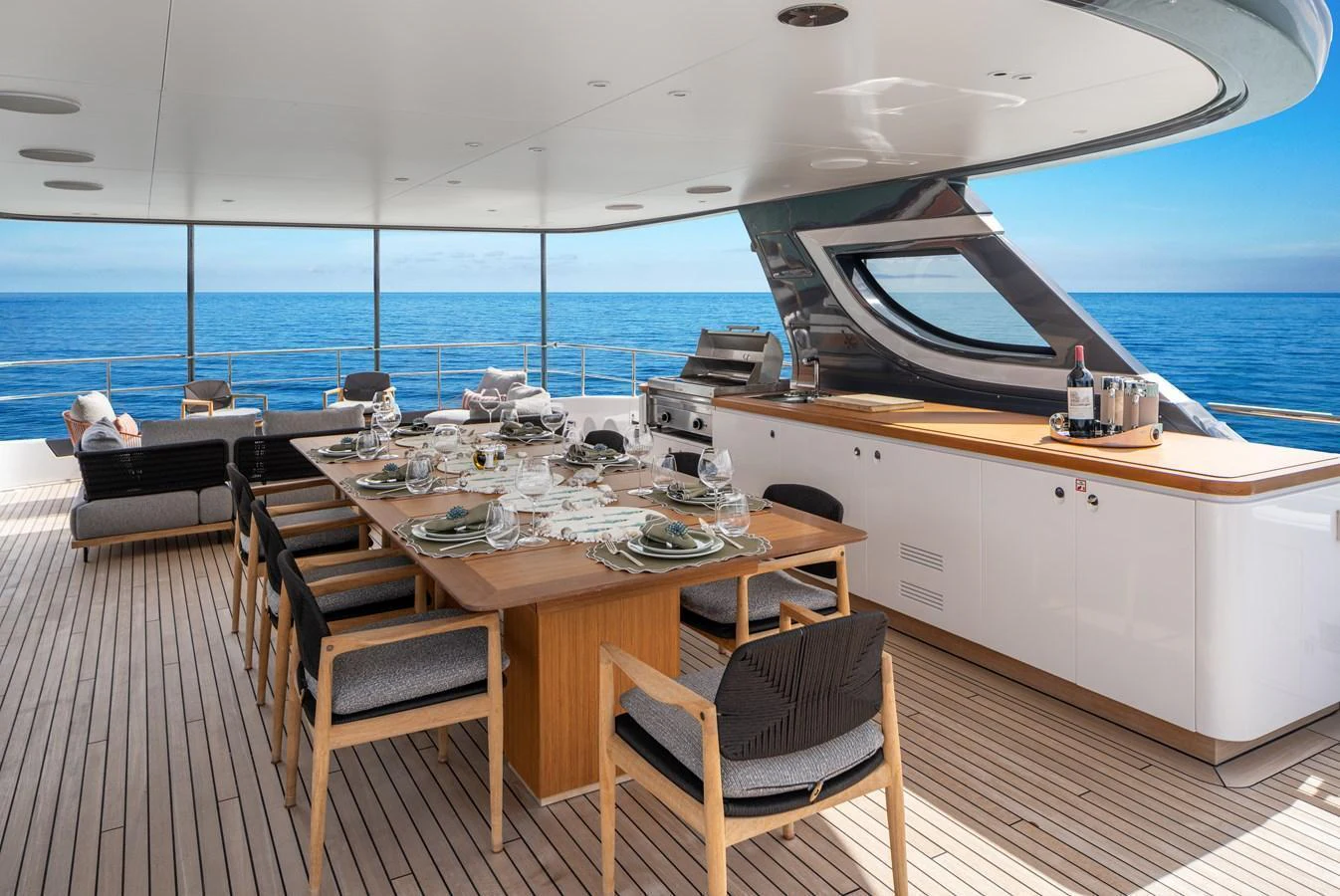 The aft deck features a spacious dining area with a stunning ocean view. aboard A+ Yacht for Sale