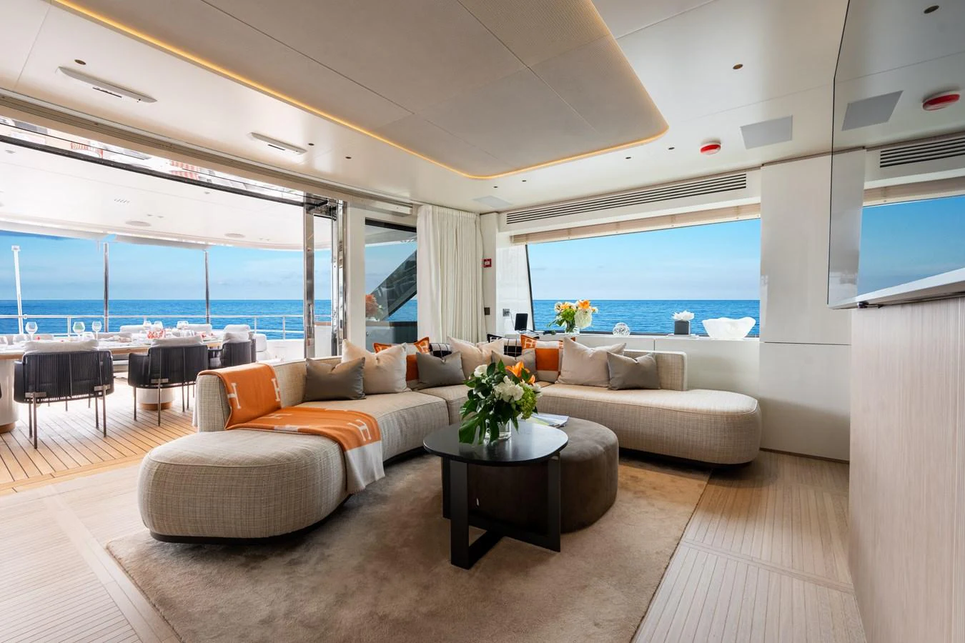 The salon offers a luxurious and spacious area with comfortable seating and stunning ocean views. aboard A+ Yacht for Sale
