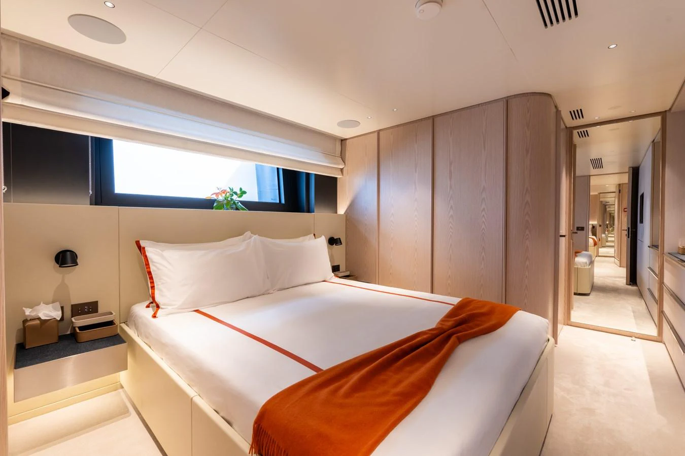 The stateroom features a luxurious bed with elegant linens and modern decor. aboard A+ Yacht for Sale