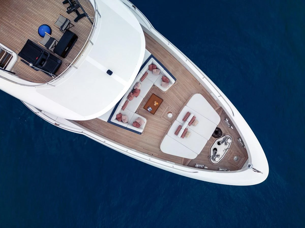 The foredeck offers a luxurious lounging area with sunbeds and a table, perfect for relaxation. aboard A+ Yacht for Sale