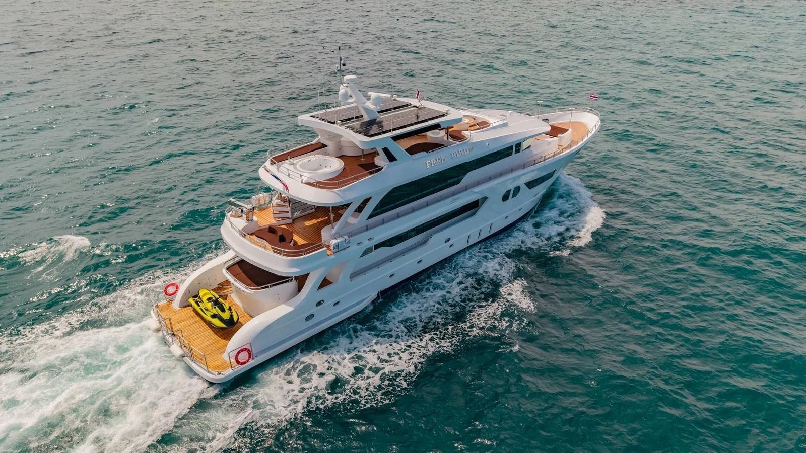 A luxurious yacht cruises through the open water, showcasing its elegant design and spacious decks. aboard FREE BIRD Yacht for Sale
