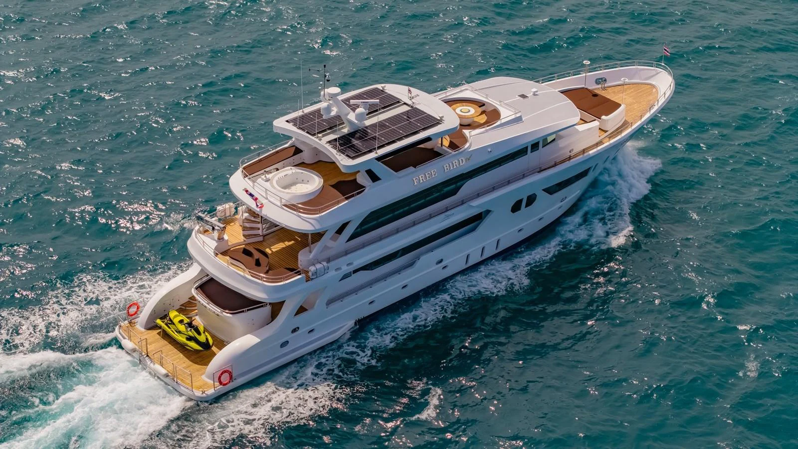 A luxurious yacht cruises through the open sea, showcasing its elegant design and spacious decks. aboard FREE BIRD Yacht for Sale