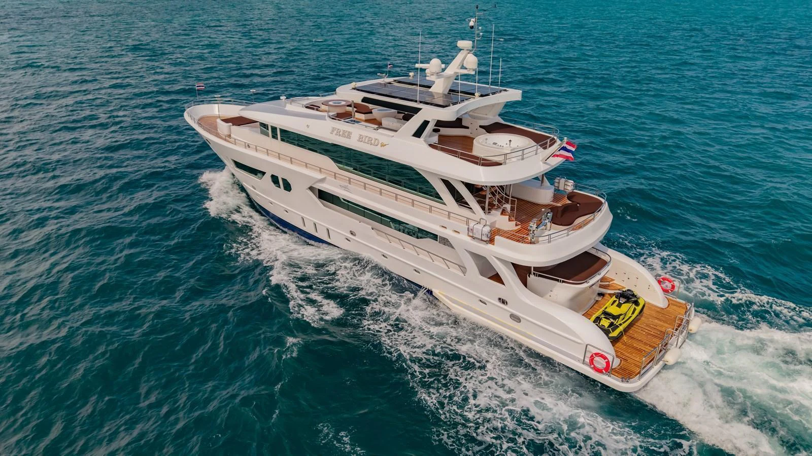 A luxurious yacht cruising through the open sea, showcasing its elegant design and spacious decks. aboard FREE BIRD Yacht for Sale
