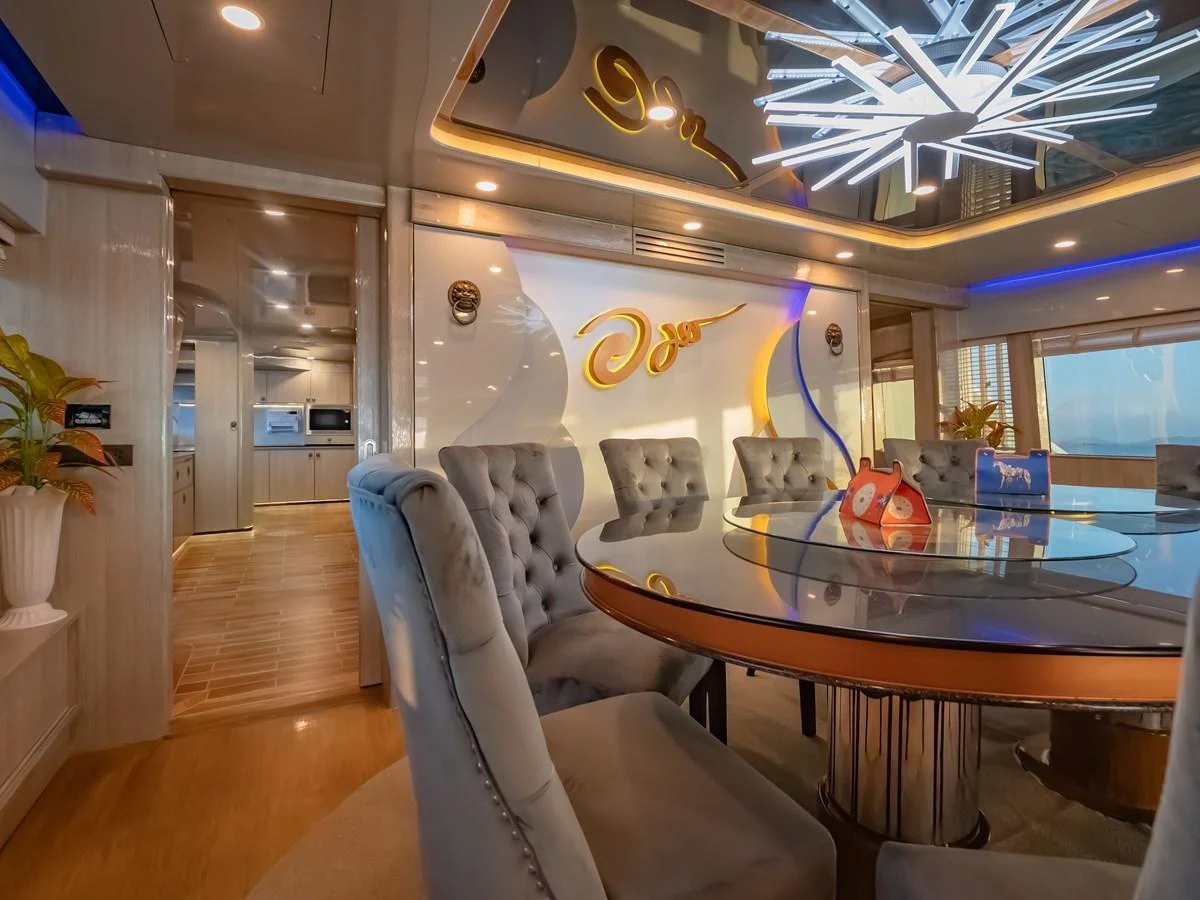 The yacht's dining area features plush seating and a modern, elegant design. aboard FREE BIRD Yacht for Sale