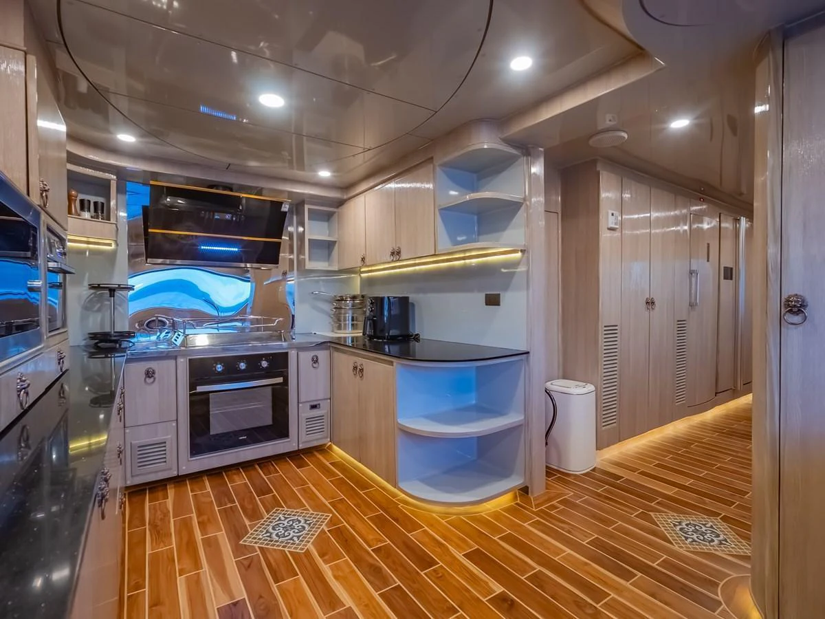 The yacht's galley features modern appliances and stylish wooden cabinetry, creating a warm and inviting space for culinary activities. aboard FREE BIRD Yacht for Sale