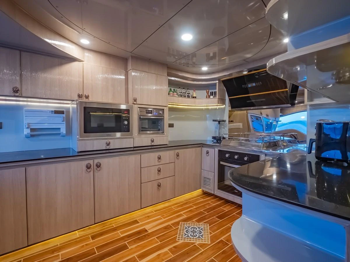The yacht's galley is equipped with modern appliances and stylish cabinetry, offering a functional and elegant cooking space. aboard FREE BIRD Yacht for Sale