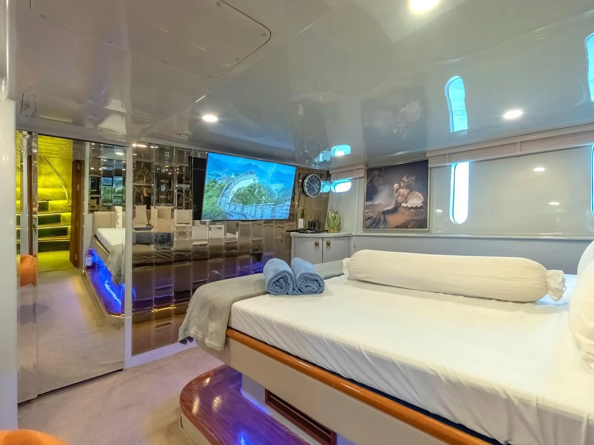 A luxurious stateroom featuring a comfortable bed and modern amenities. aboard FREE BIRD Yacht for Sale