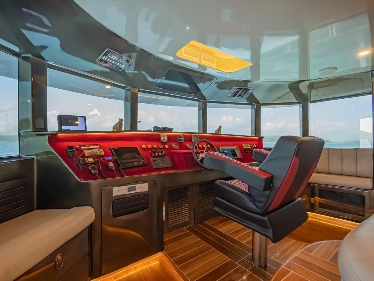 The helm station features a sleek design with modern navigation equipment and luxurious seating. aboard FREE BIRD Yacht for Sale