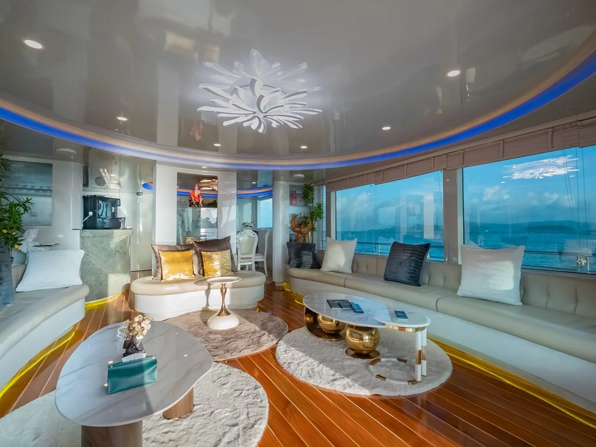 The spacious salon features luxurious seating with panoramic ocean views. aboard FREE BIRD Yacht for Sale
