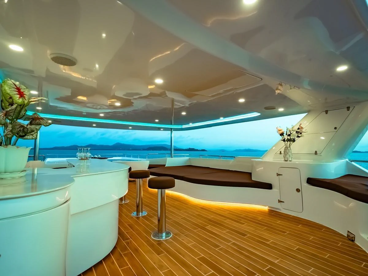 A luxurious salon with modern furnishings and panoramic views of the sea. aboard FREE BIRD Yacht for Sale