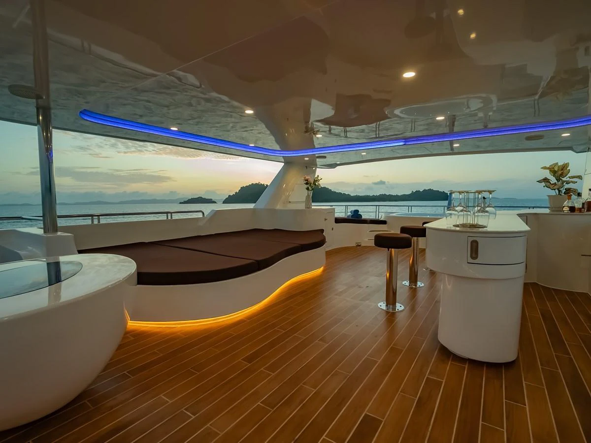 The aft deck offers a luxurious space with comfortable seating and a stunning view of the ocean. aboard FREE BIRD Yacht for Sale