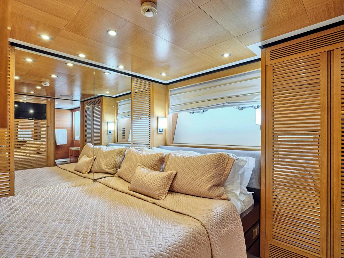 The master stateroom features a luxurious bed with elegant bedding and ample natural light. aboard VENETICO Yacht for Sale