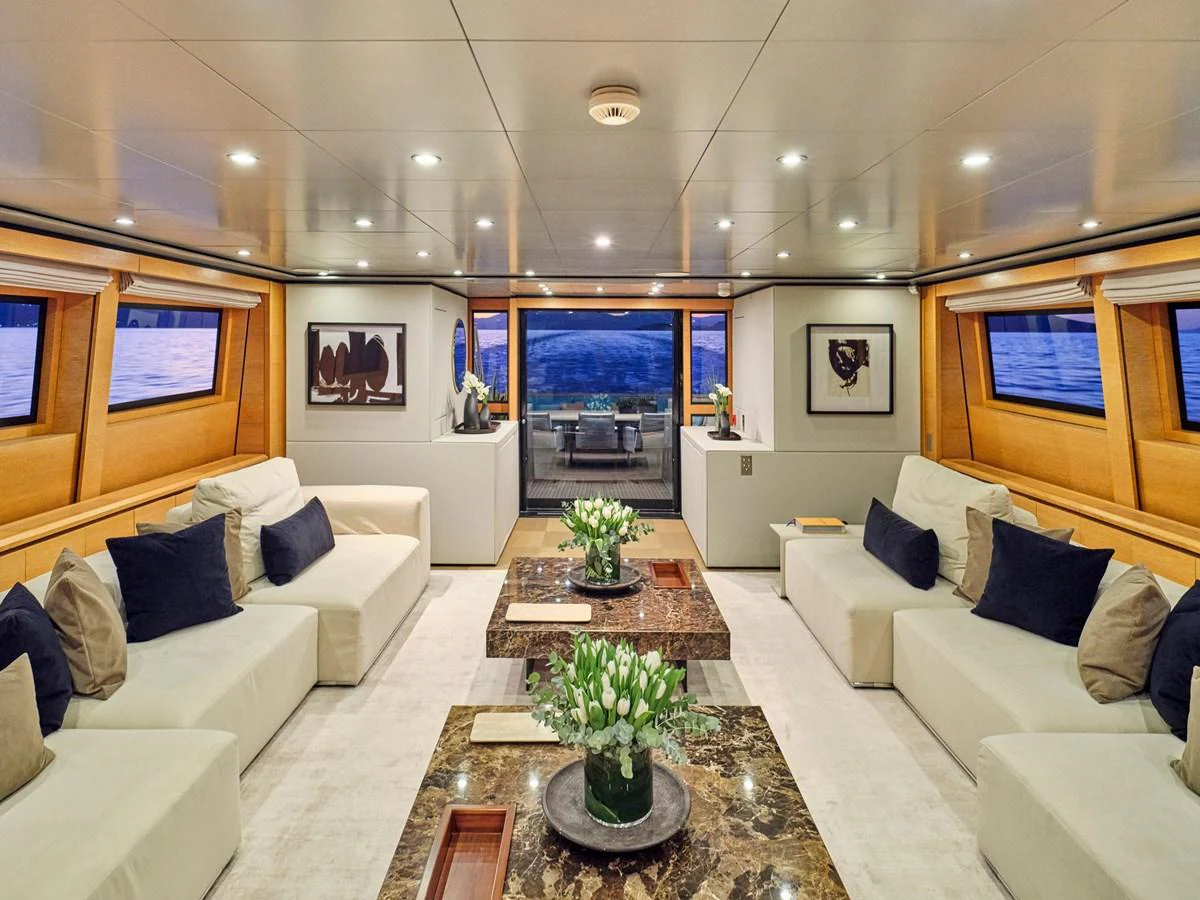 The luxurious salon features plush seating, elegant decor, and expansive windows offering stunning sea views. aboard VENETICO Yacht for Sale