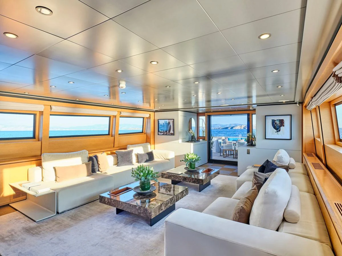 The yacht's salon features luxurious seating, elegant decor, and expansive windows offering stunning sea views. aboard VENETICO Yacht for Sale