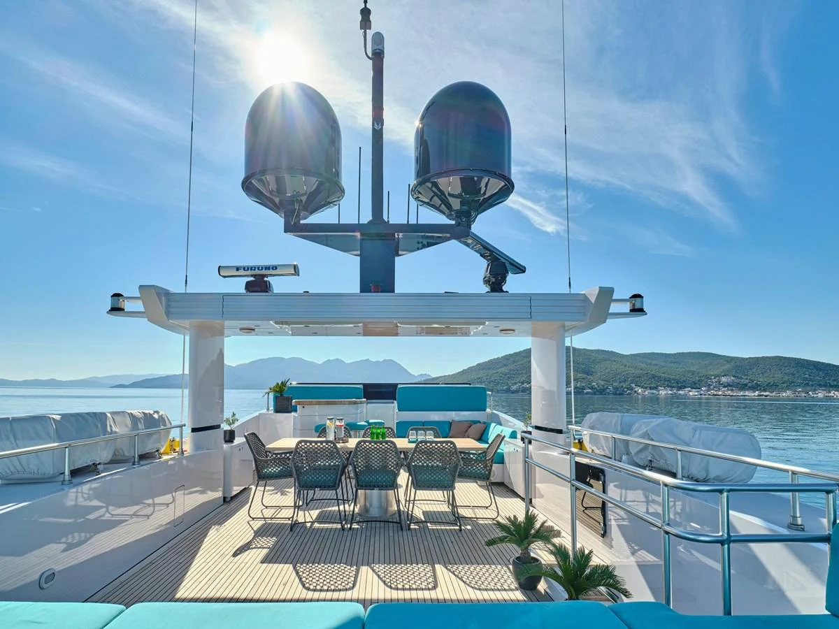 The yacht's flybridge offers a spacious and inviting area for alfresco dining and relaxation with stunning views. aboard VENETICO Yacht for Sale