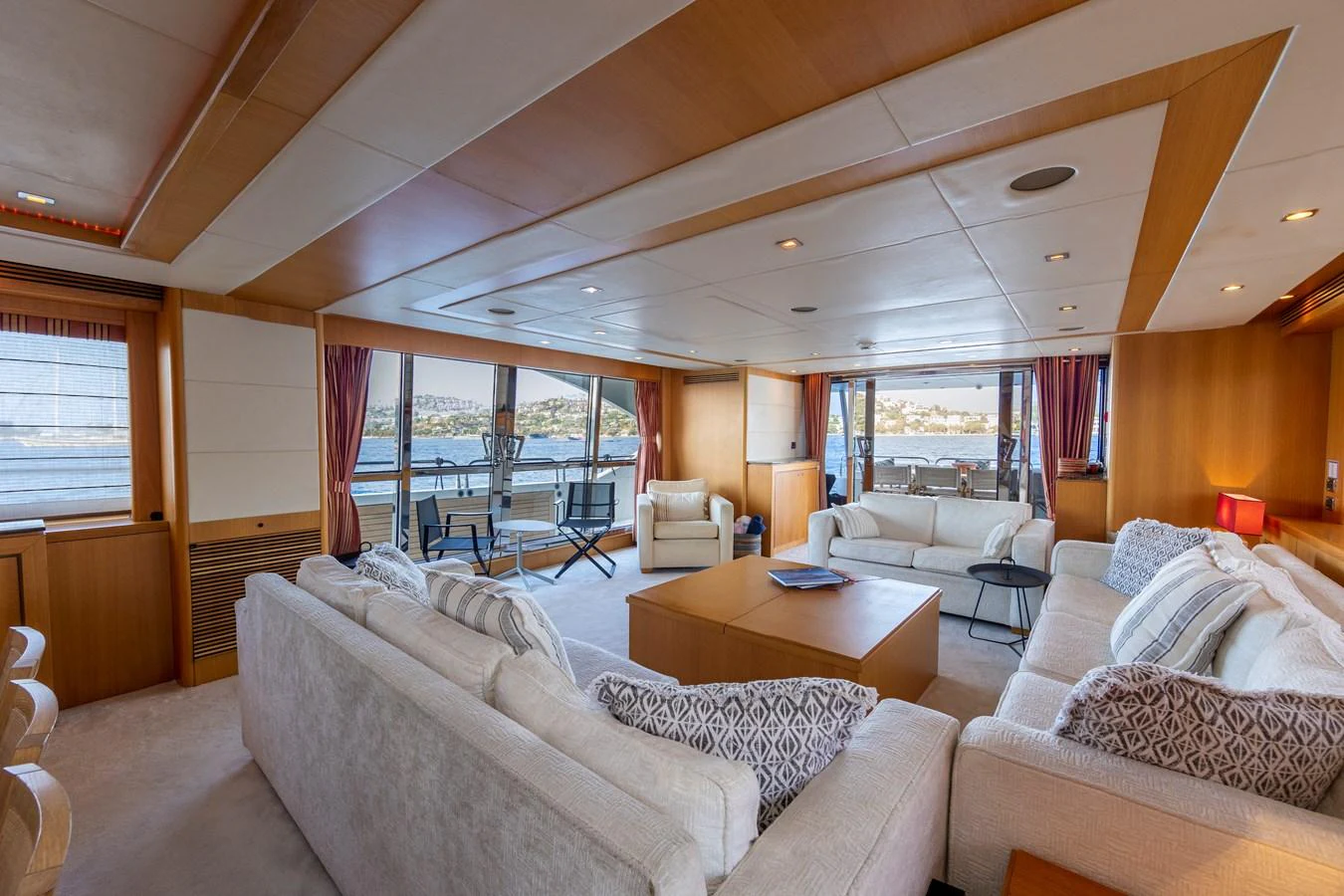 The spacious salon features comfortable seating and large windows offering stunning views. aboard FINAL CUT Yacht for Sale