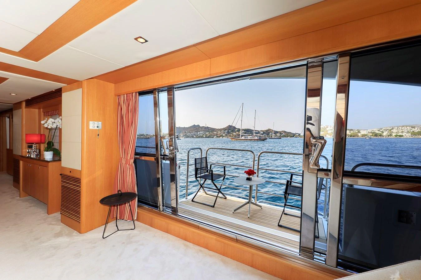 The salon features large sliding glass doors that open to a scenic view of the water. aboard FINAL CUT Yacht for Sale